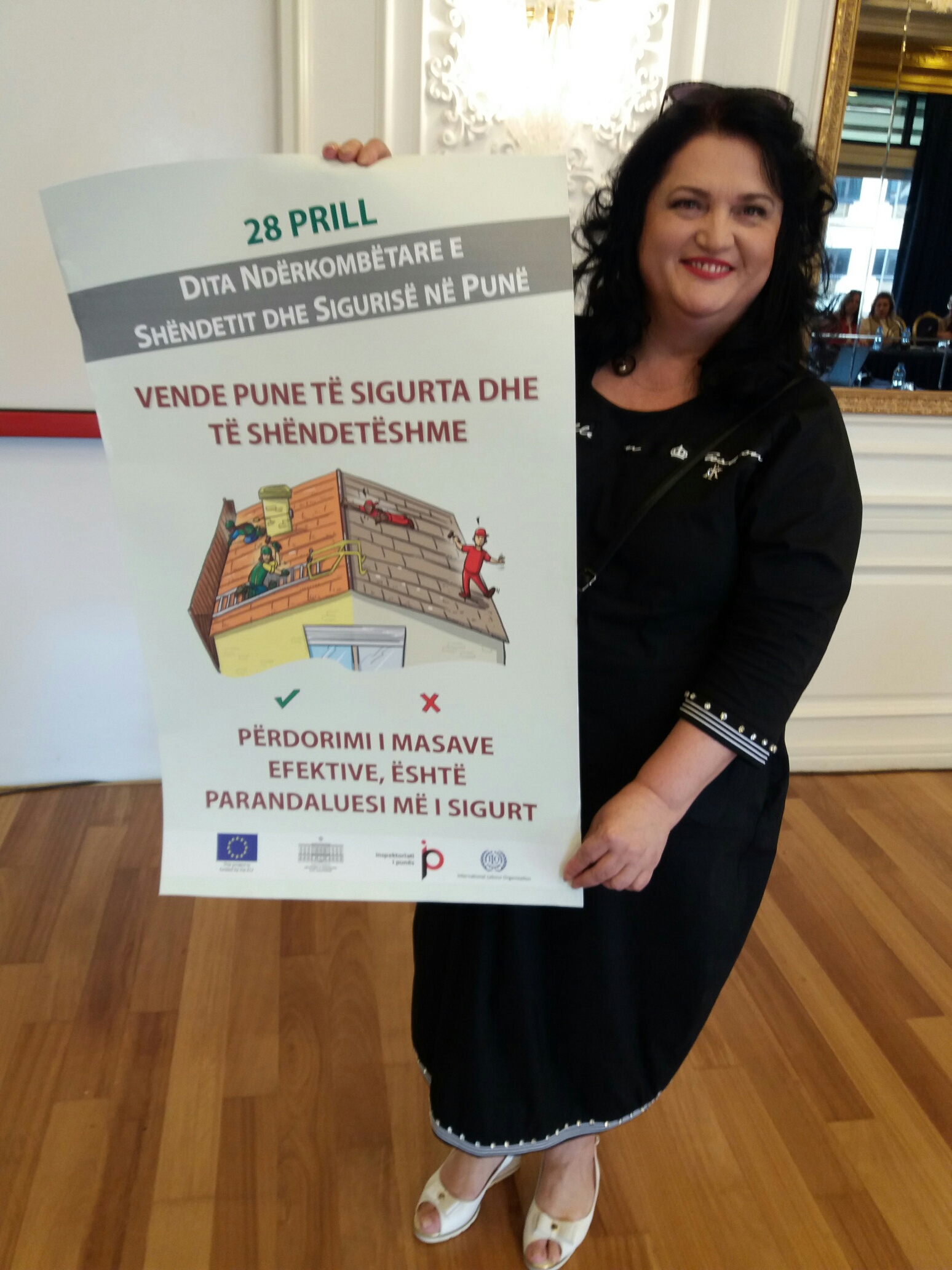 ILO National Coordinator in Albania, Zhulieta Harasani with poster for the Albanian labour inspection campaign